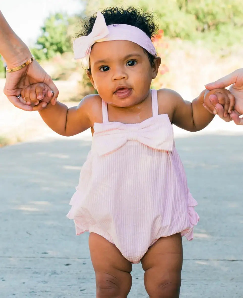 RuffleButts + RuggedButts - Baby Girls Pink Seersucker Bow Front Bubble Woven Romper